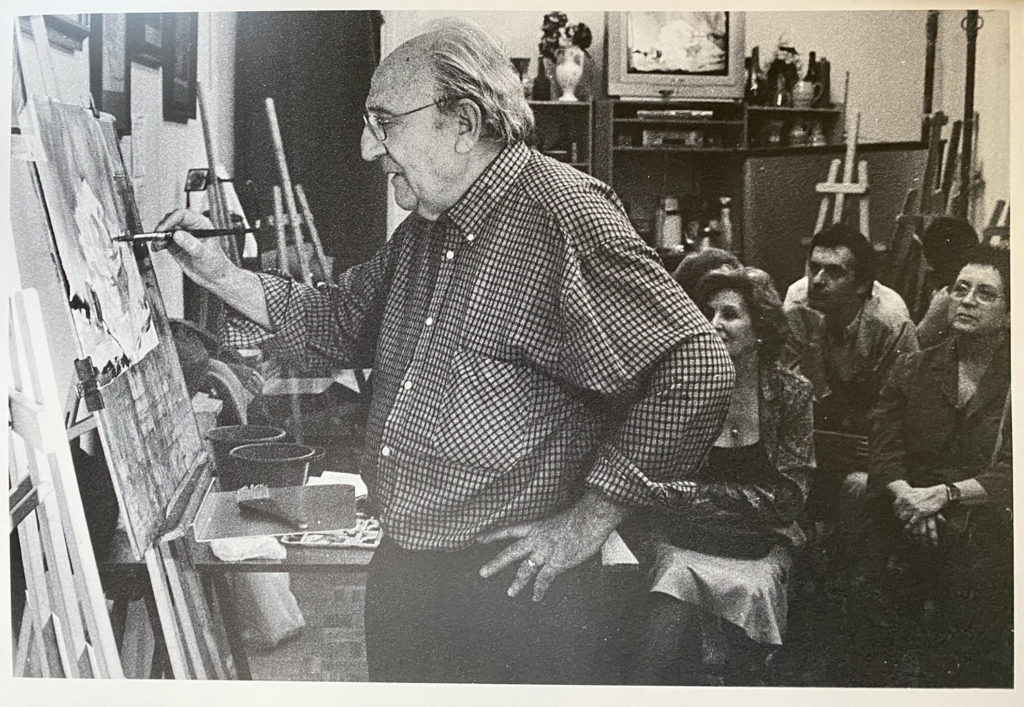 Luis Borruel demonstrating at the easel to a seated group of workshop students